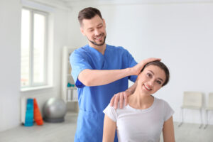 Chiropractor working with female patient in clinic