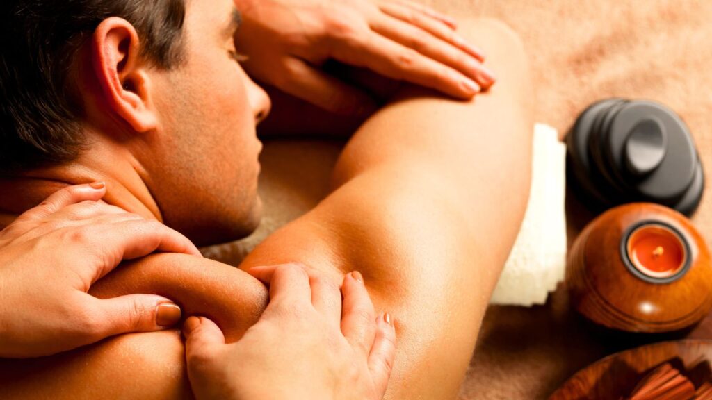 A close-up of a clinician's hands performing Active Release Therapy (ART) on a patient's shoulder and upper back to restore range of motion in Fort Lauderdale.