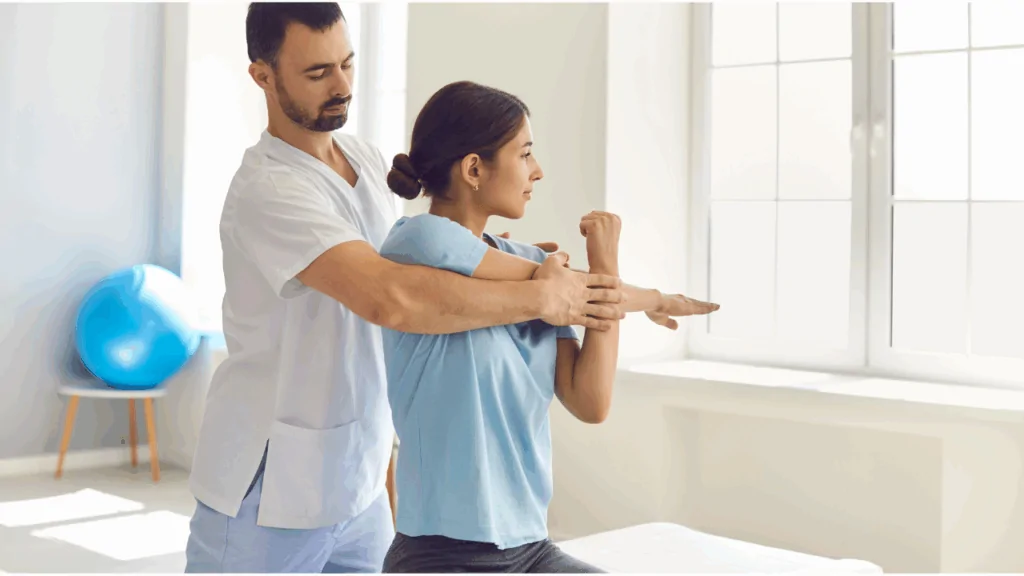 A chiropractor guiding a female patient through a therapeutic arm and shoulder stretch to provide chiropractic pain relief treatment at Spine and Joint Center in Fort Lauderdale.