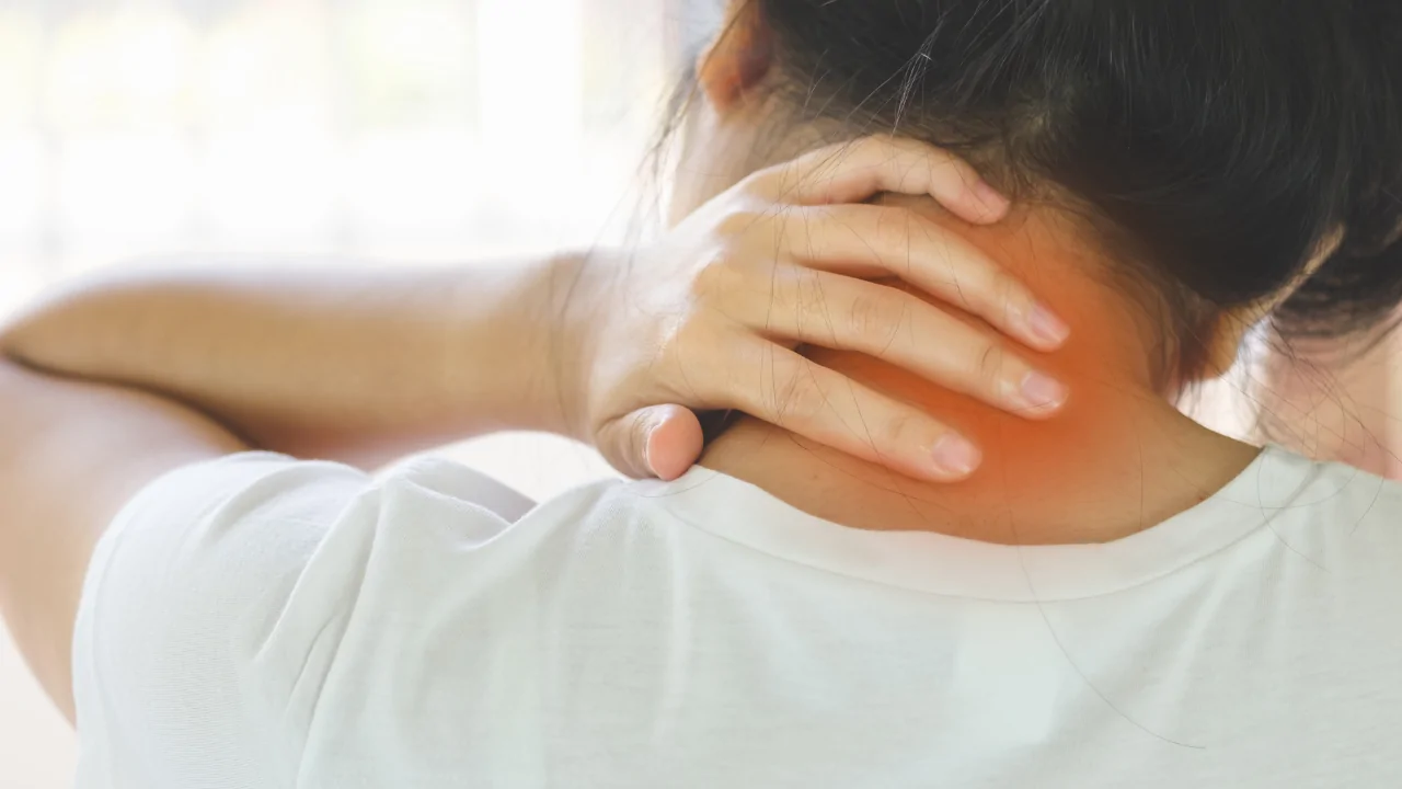 A person holding their neck in pain with a glowing red area to represent the symptoms of tech neck seeking text neck treatment in Fort Lauderdale.