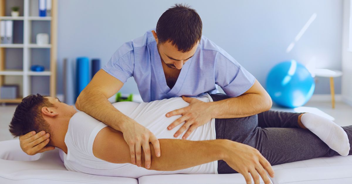 A chiropractor in a blue medical shirt performing a manual myofascial release technique on a patient’s lower leg to provide specialized plantar fasciitis chiropractic care at Spine and Joint Center in Fort Lauderdale.